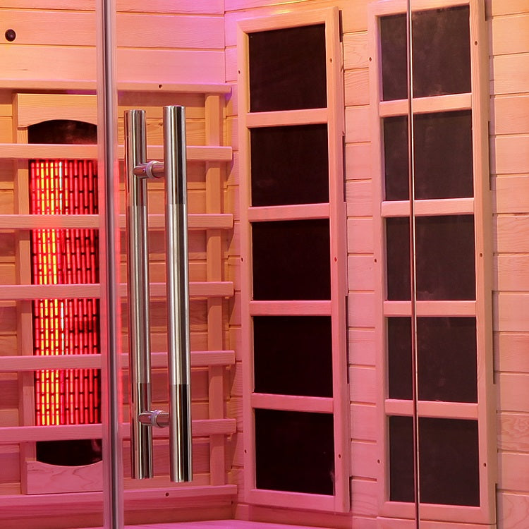 Interior view of a Full Spectrum Infrared Sauna featuring red heaters and wooden panels.