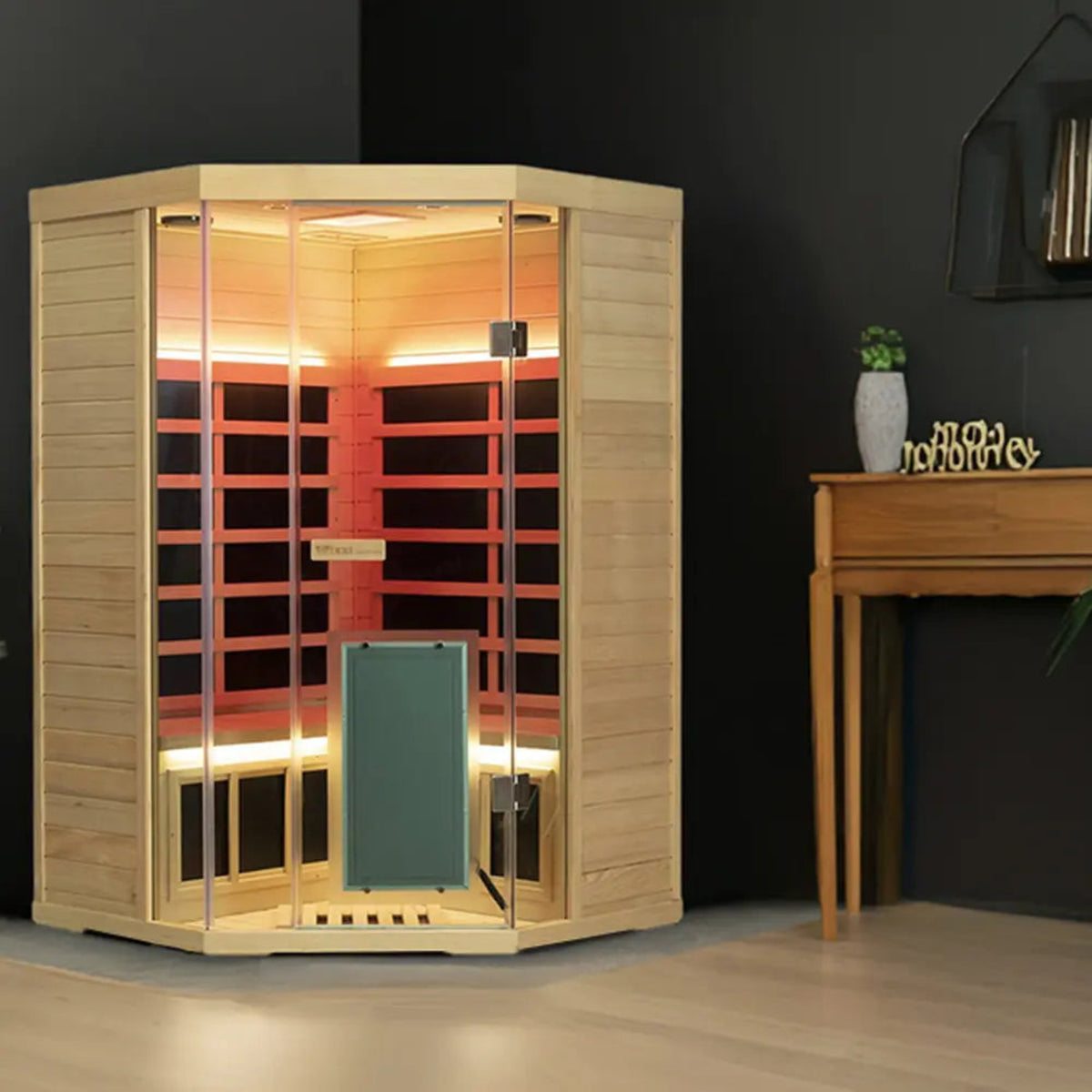Corner infrared sauna for 2-3 people by Wizzisaunas, featuring sleek design and interior lighting.