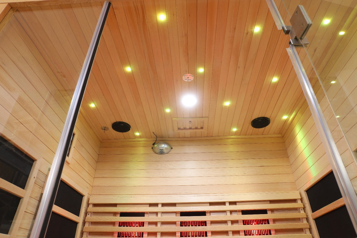 Interior view of the Blisspod Venetian full spectrum infrared sauna showcasing wood paneling and lighting.