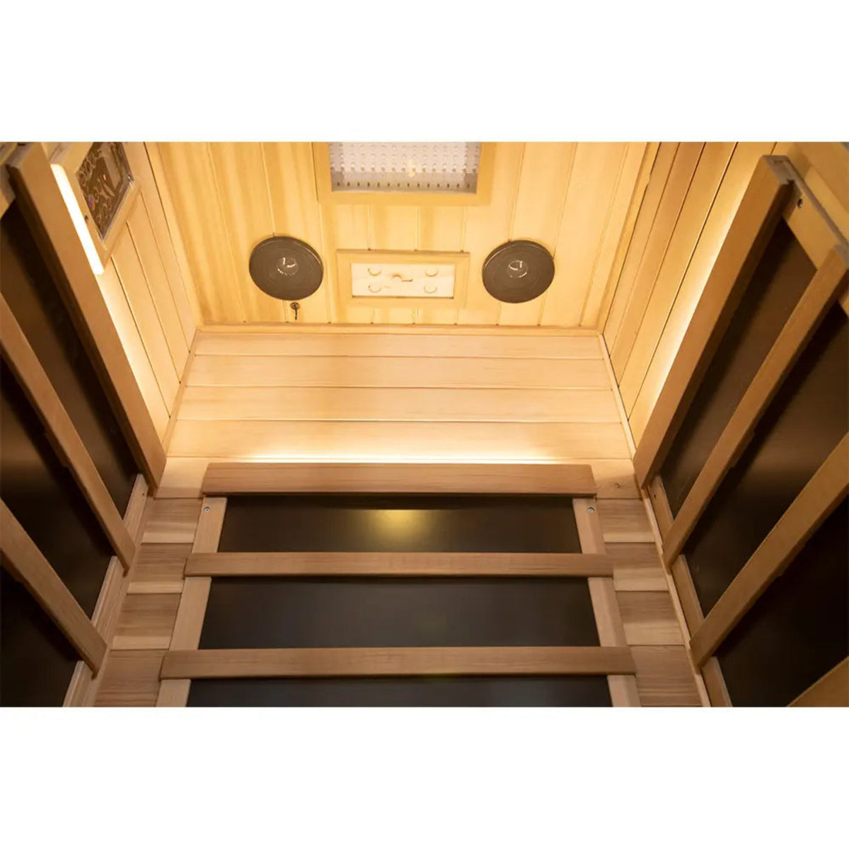 Interior view of 1-person infrared sauna red cedar with lighting and wooden panels.