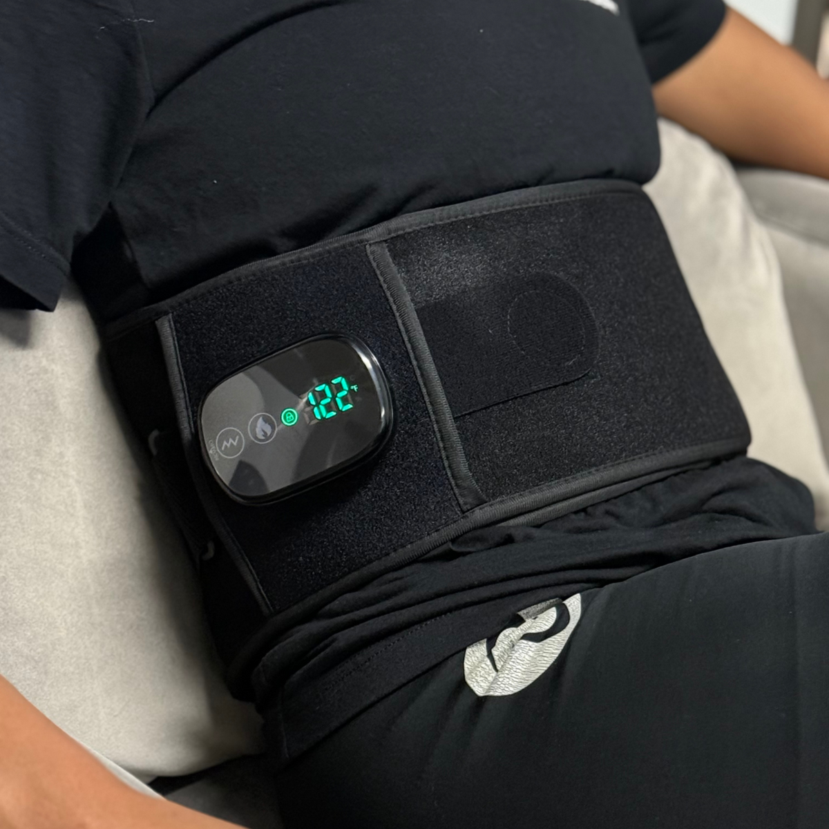 TheraBelt Red Light Therapy Belt worn on a waist with digital display showing temperature.