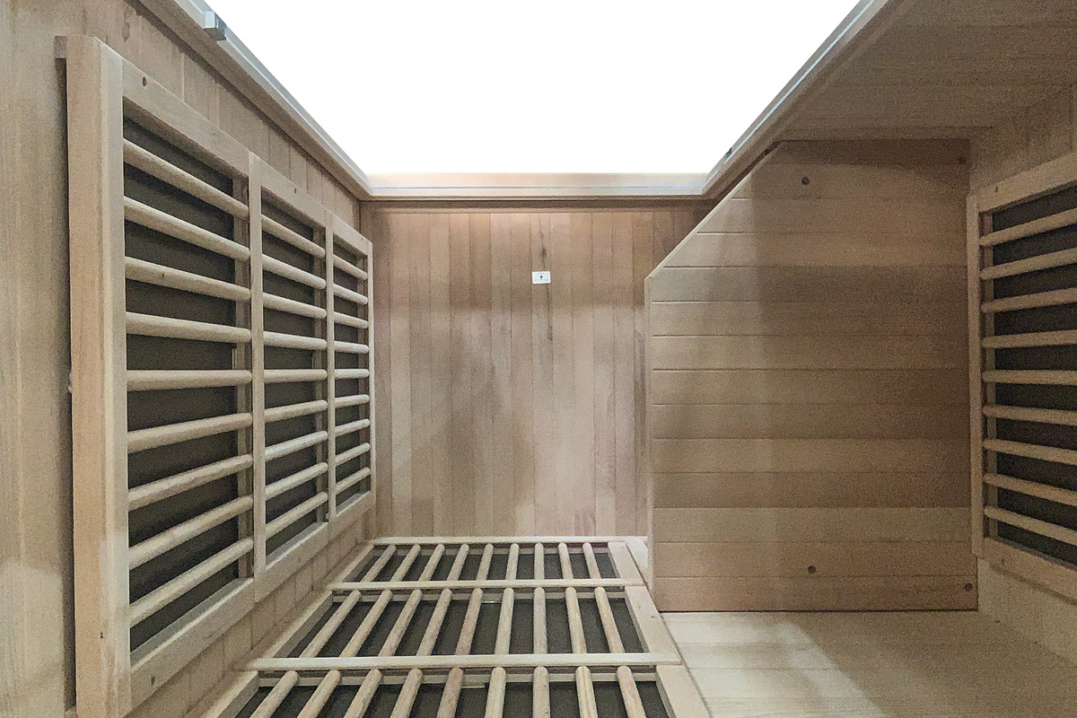 Interior view of Blisspod Vienna 1-Person Far Infrared Sauna showcasing Canadian Hemlock wood and sleek design.