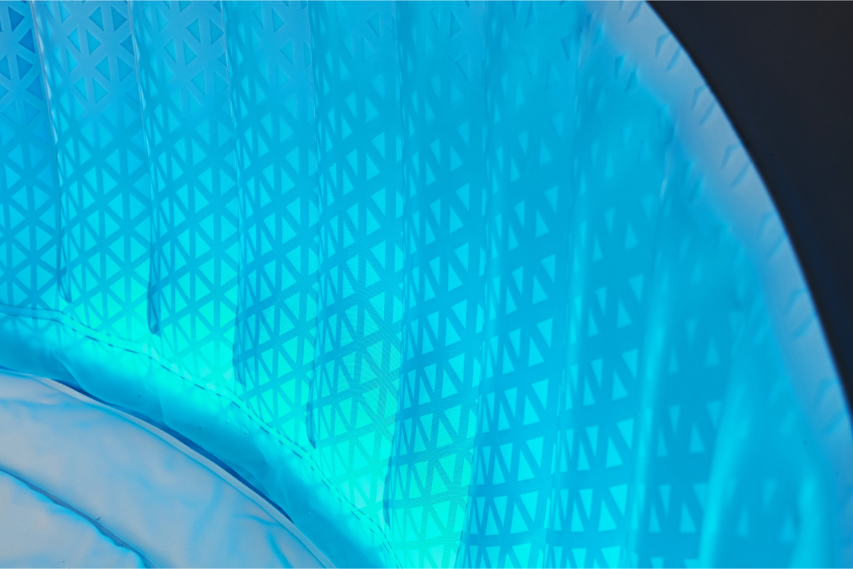 Close-up of a hot tub wall, geometric-patterned wall with a blue light.