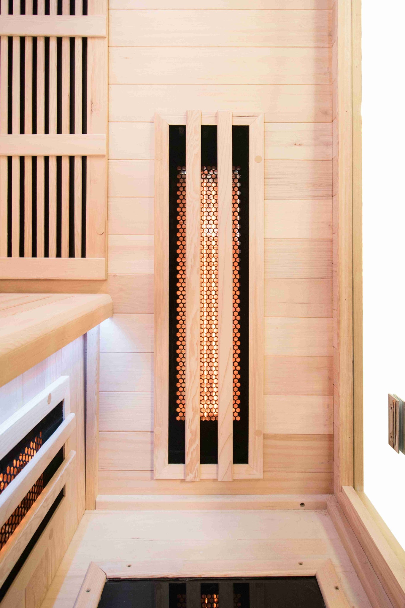 Nicebeam Canadian Hemlock Infrared sauna with wooden walls and a heating element.