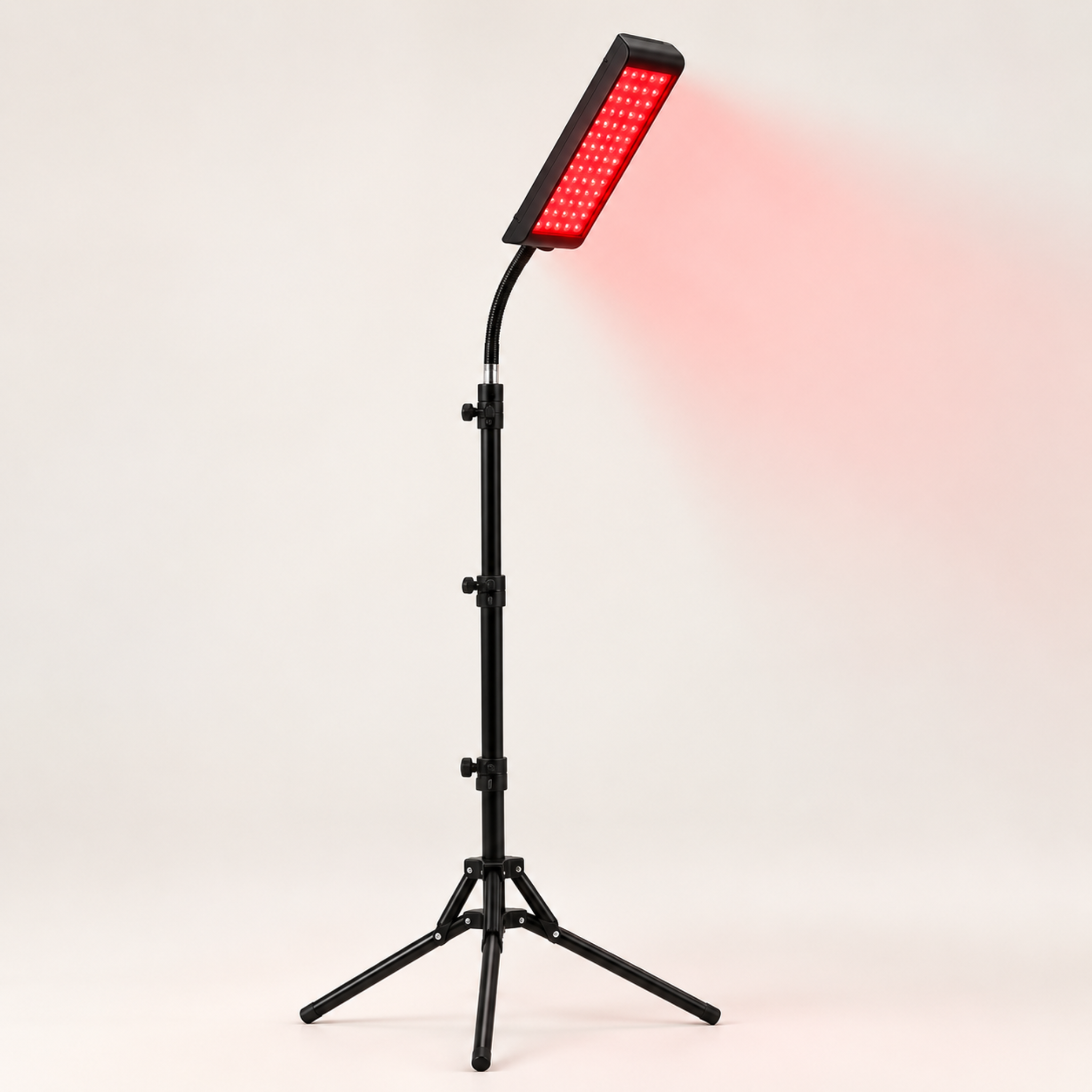 NIcebeam red light therapy lamp on a white background showing a red glow.