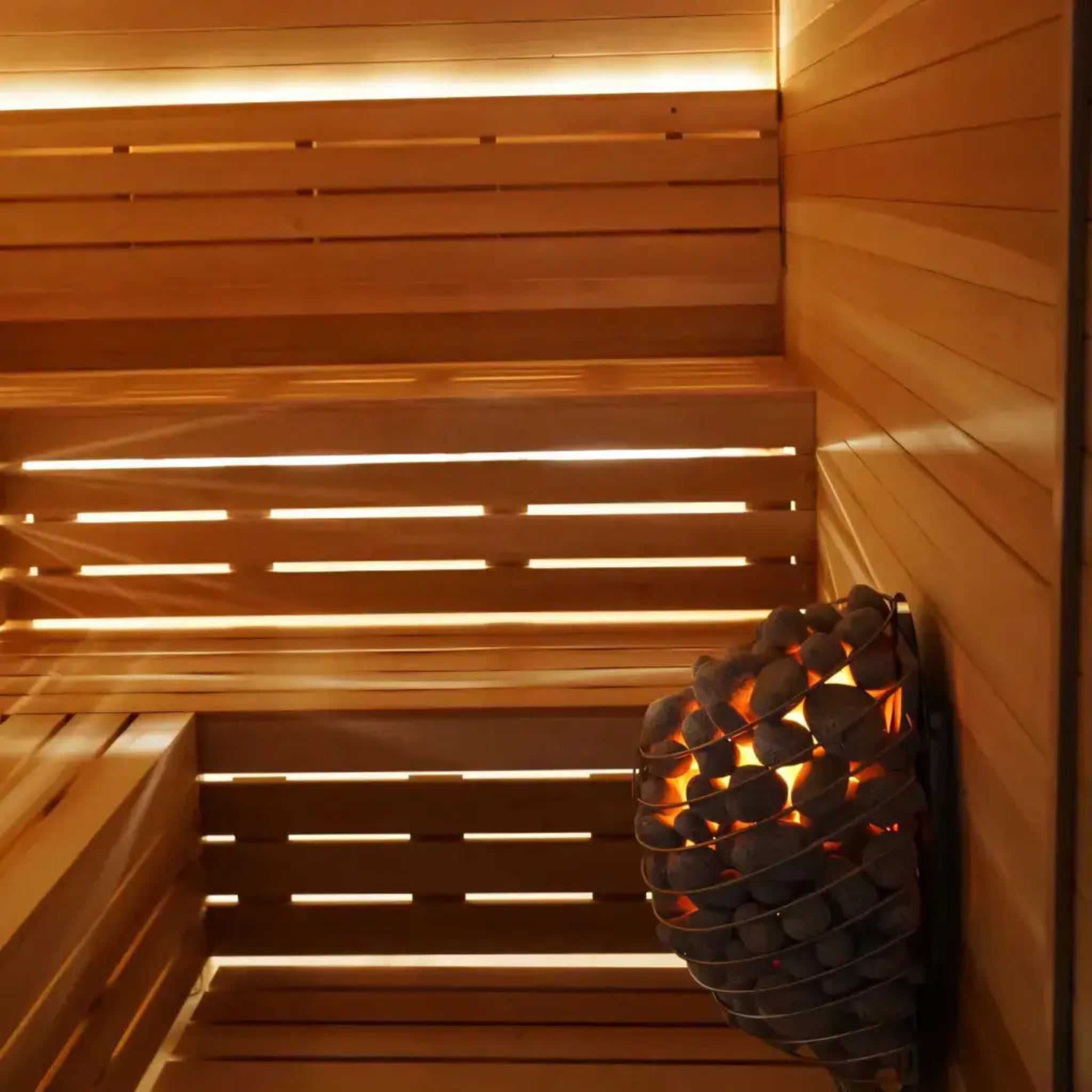 Wooden sauna interior with a lit candle holder on the wall.
