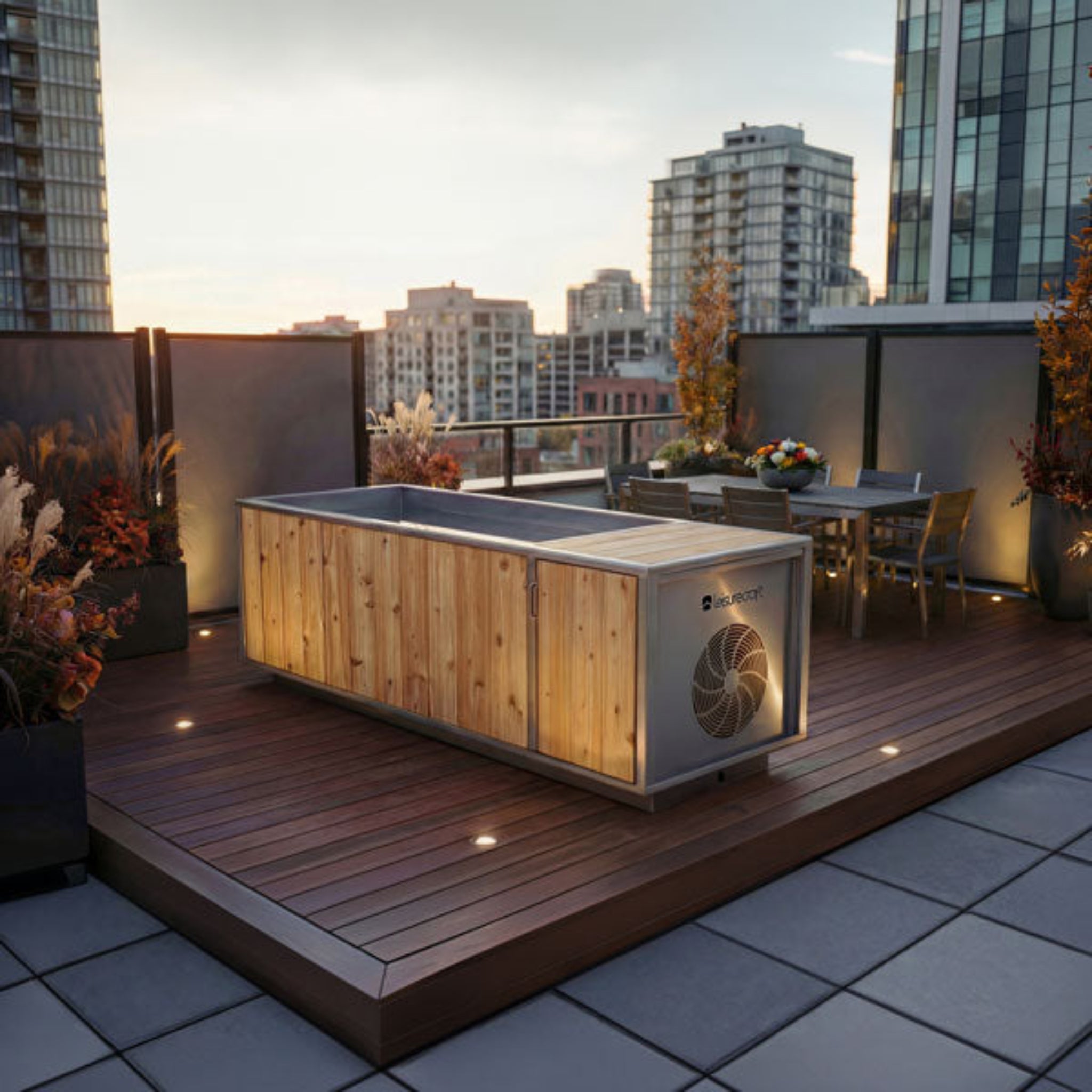 Dundalk LeisureCraft Flow Cold Plunge | Cedar & Stainless Steel in a modern urban patio setting with flowers.