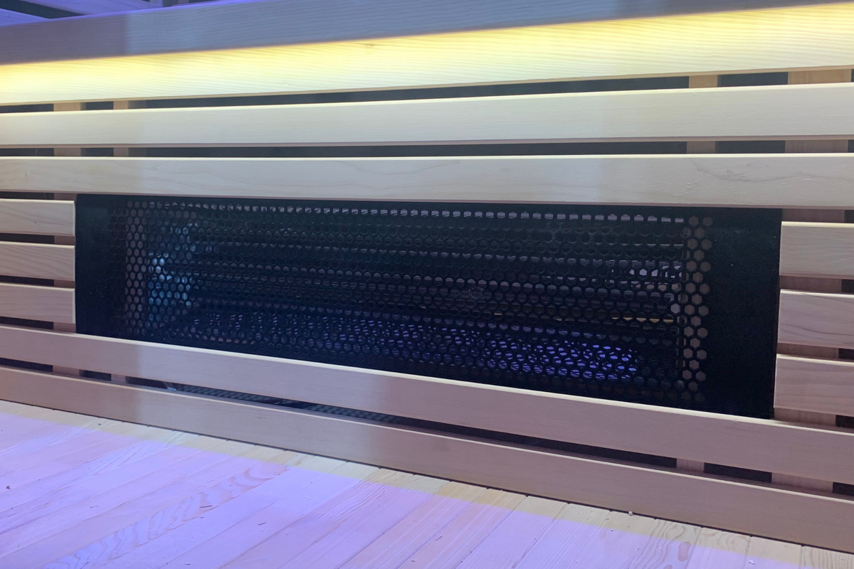 Full Spectrum Indoor Sauna heater panel with ambient lighting in modern wooden design.