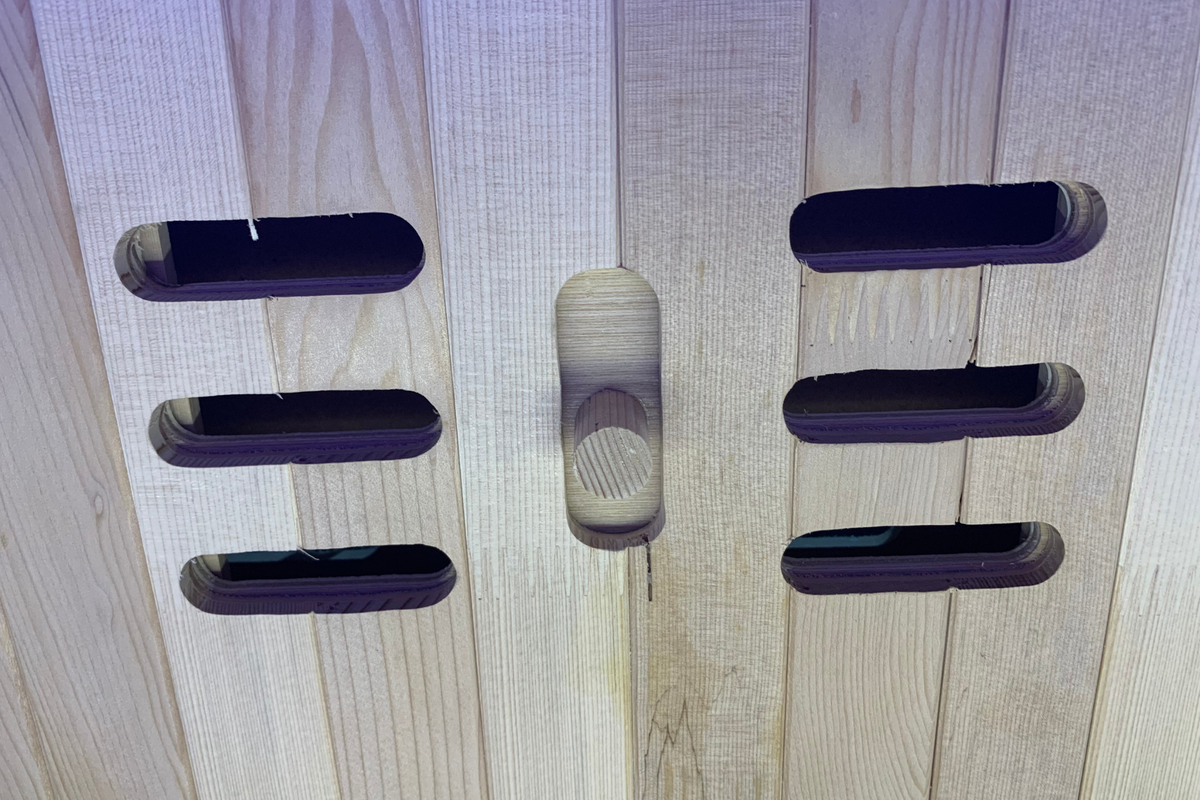 Detail view of the wooden panel structure for the Full Spectrum Indoor Sauna, highlighting ventilation openings.