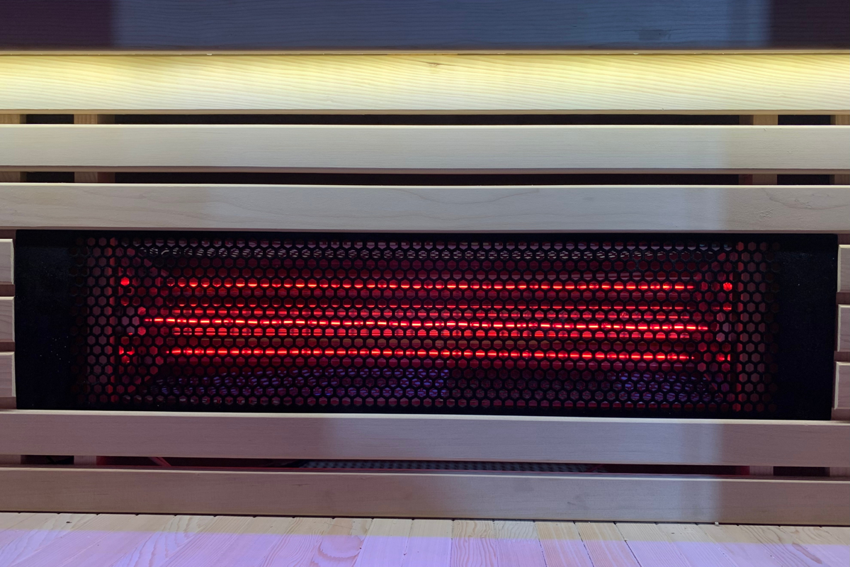 Full Spectrum Indoor Sauna red light therapy panel showcasing glowing infrared bulbs.