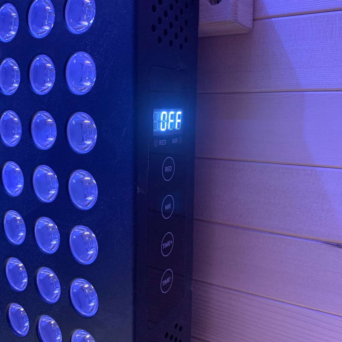 Control panel of the Full Spectrum Indoor Sauna featuring red light therapy settings and timer options.