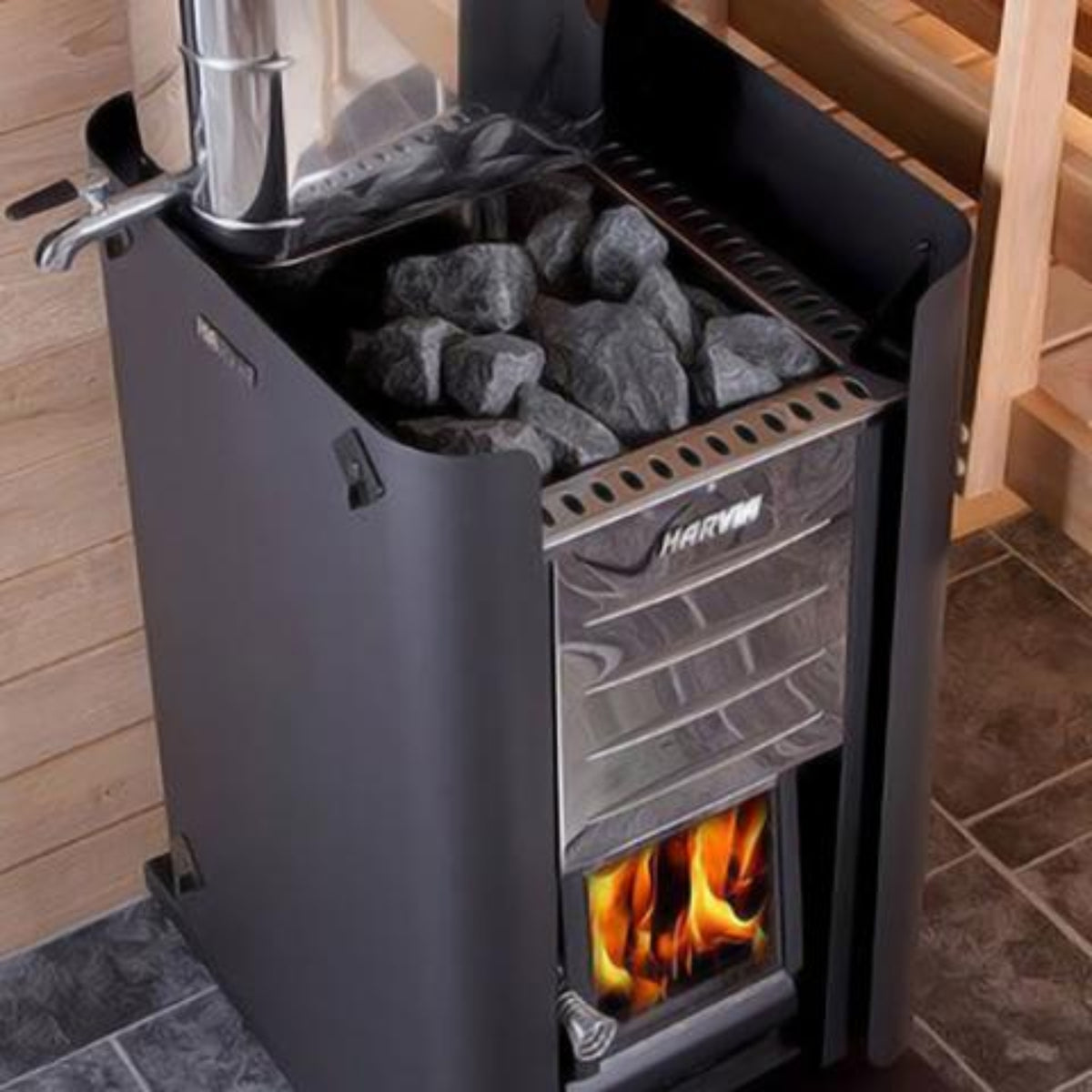 Harvia Sauan stove with visible flames inside, set against a wooden wall.