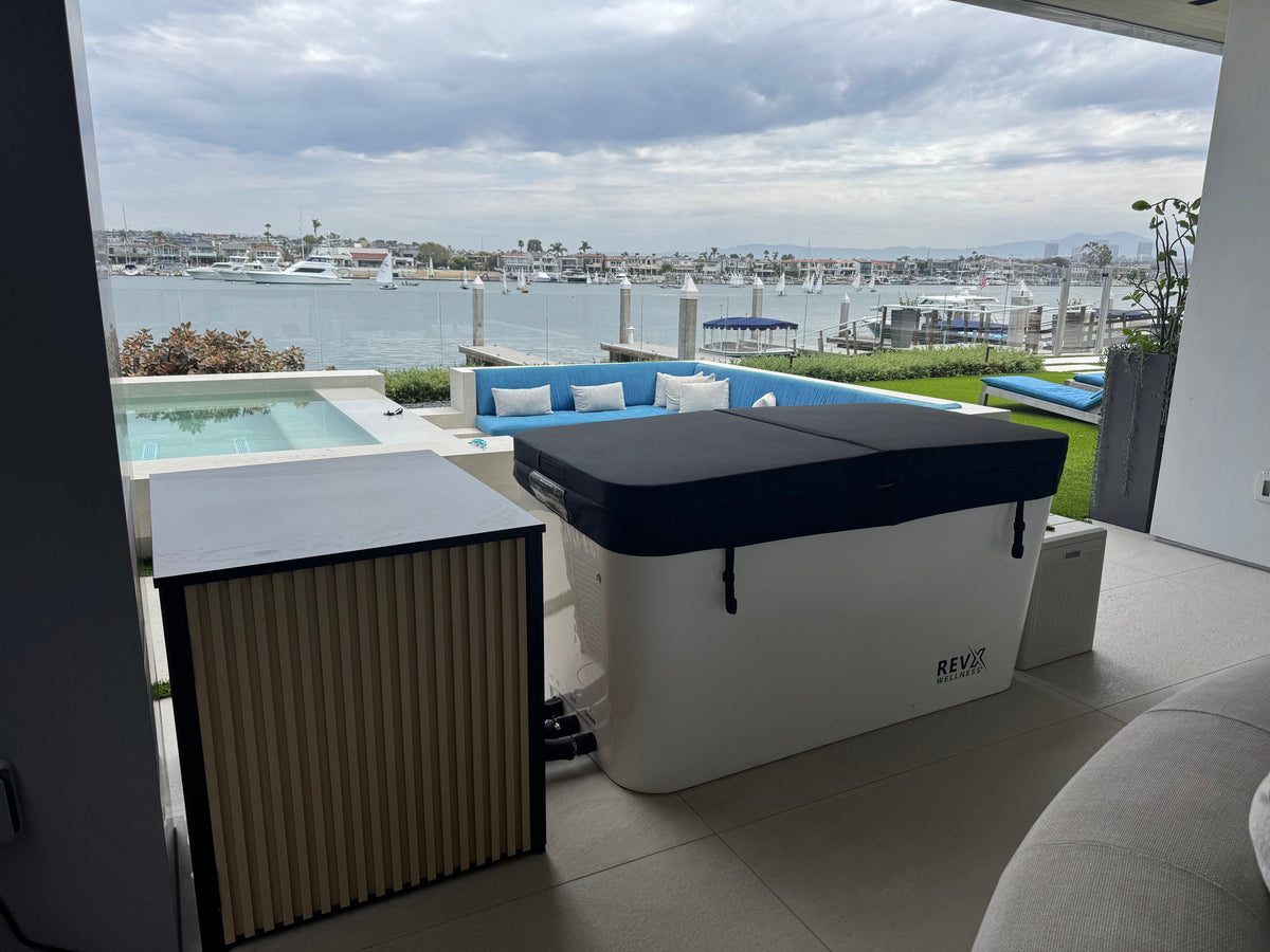 RevX Acrylic X Tub with covered tub and LUX cabinet overlooking a waterfront