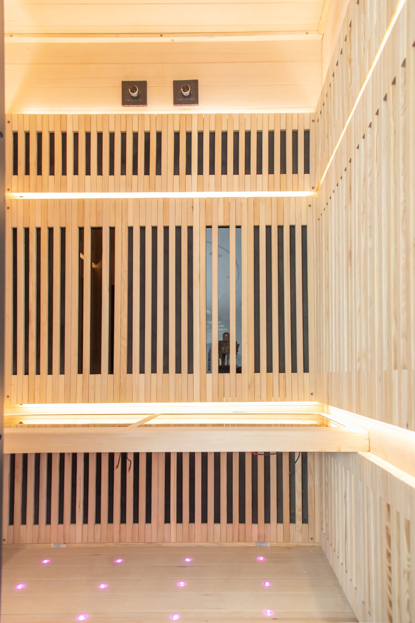 Wooden sauna interior with slatted walls and bench seating inside the Nicebeam Canadian Hemlock sauna