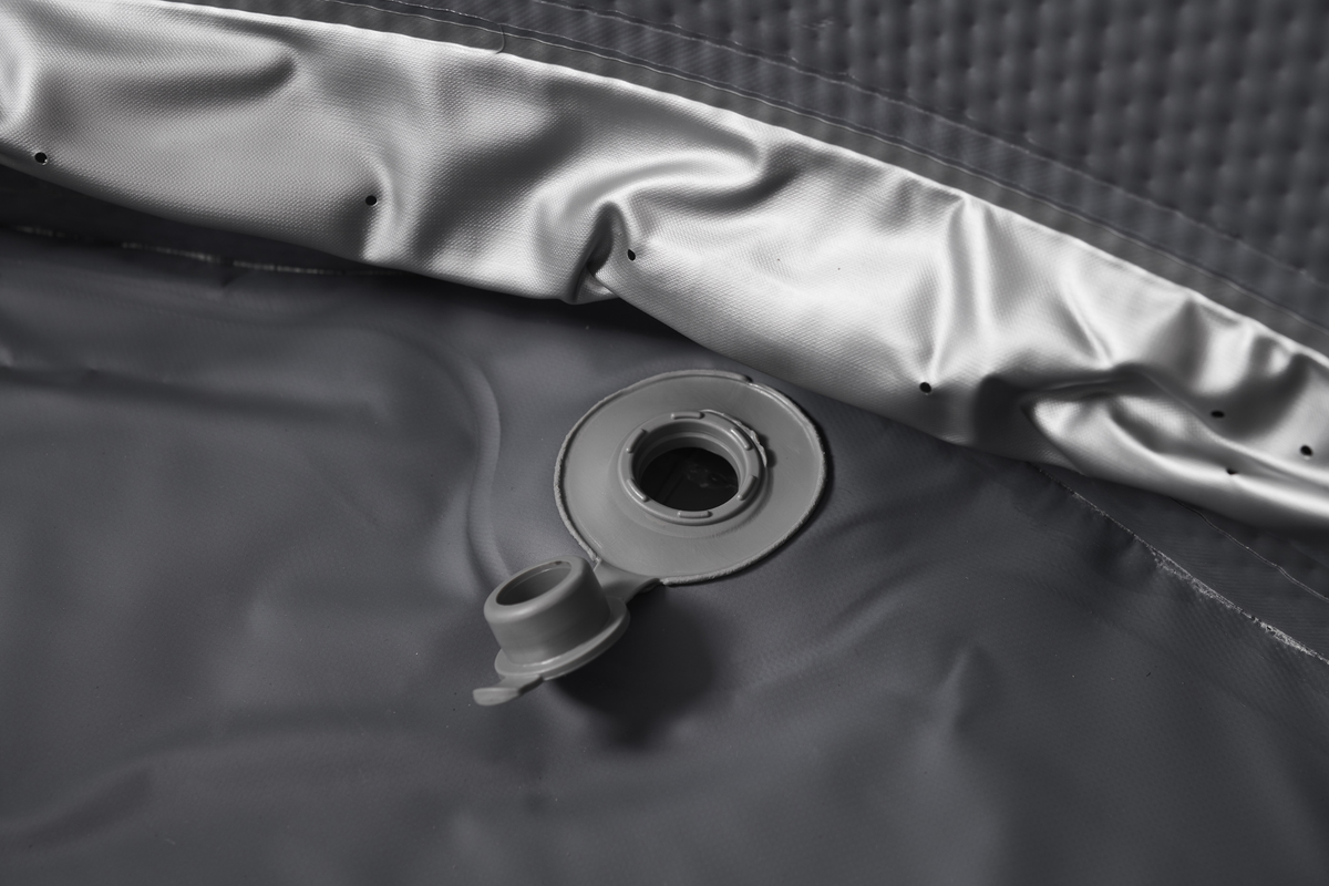 Close-up of the valve and inner lining of a rigid hot tub for optimal inflation and maintenance.