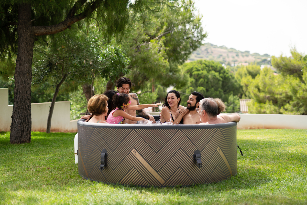 Relaxing in a rigid hot tub with friends in a scenic outdoor setting, perfect for socializing and enjoying nature.