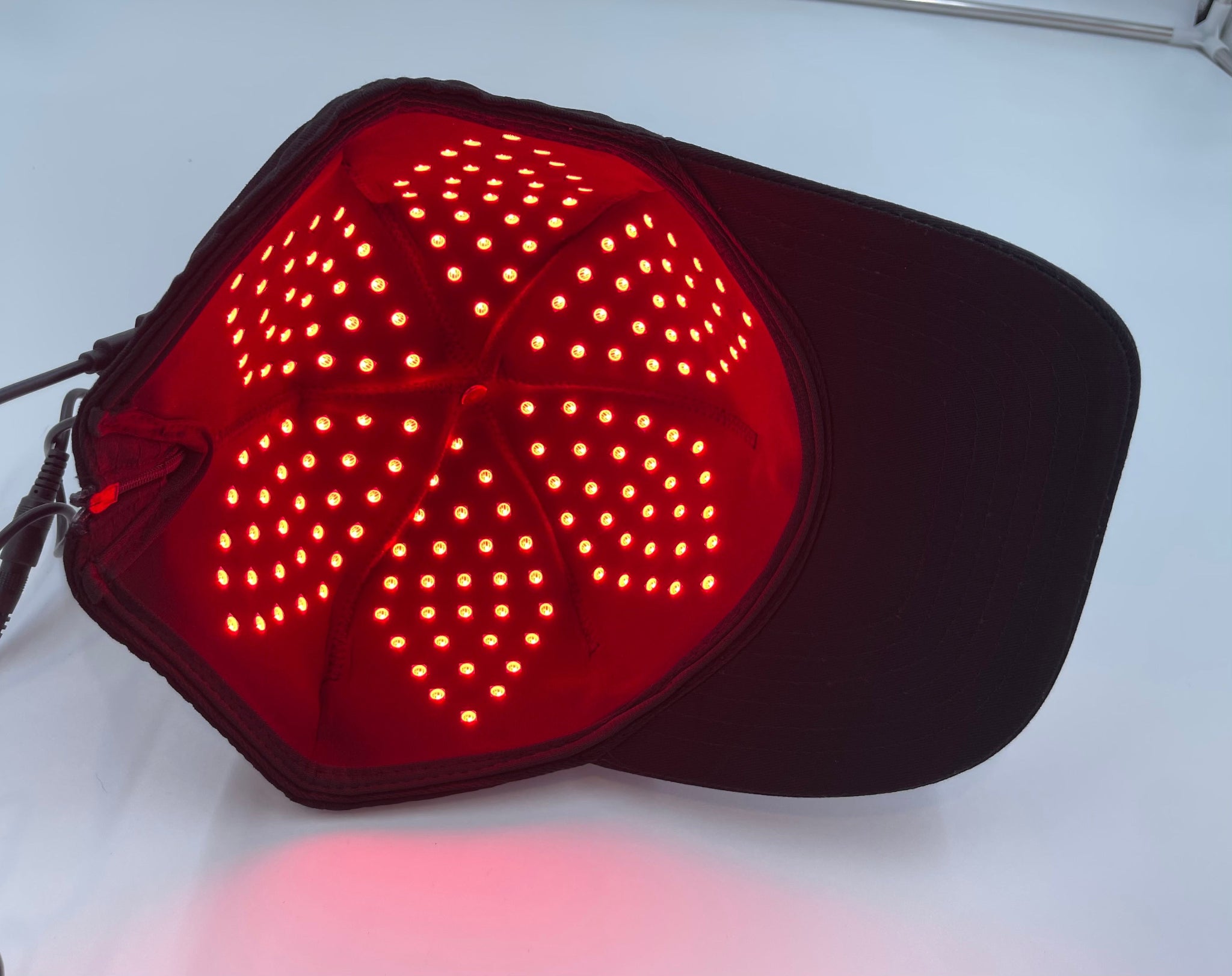 Model wearing Red Light Pro Devices red light therapy hat for scalp and hair regrowth treatment