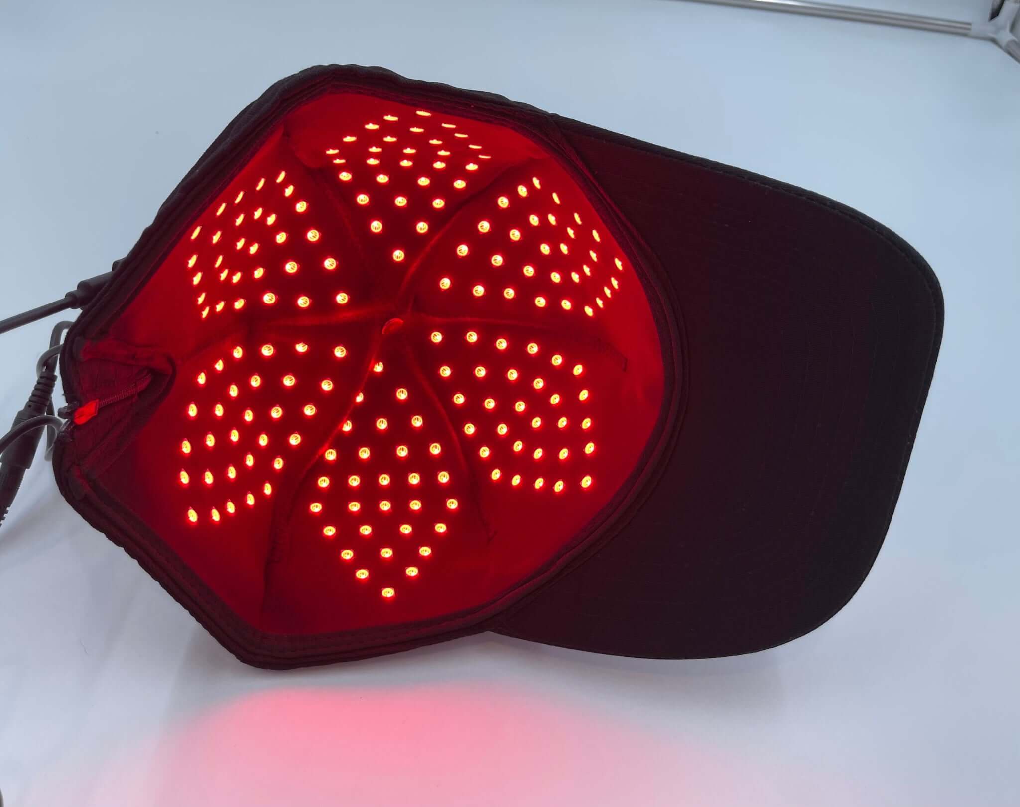 Model wearing Red Light Pro Devices red light therapy hat
