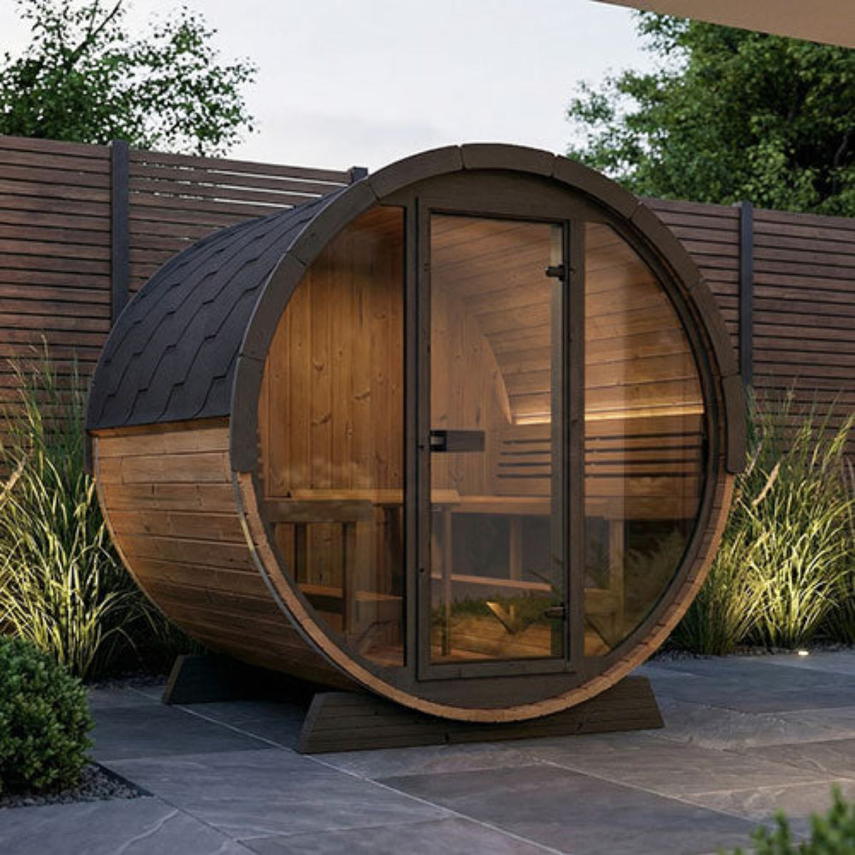 SaunaLife Ergo Elegance-Series Model EE8G Outdoor Barrel Sauna with glass door in a garden setting.