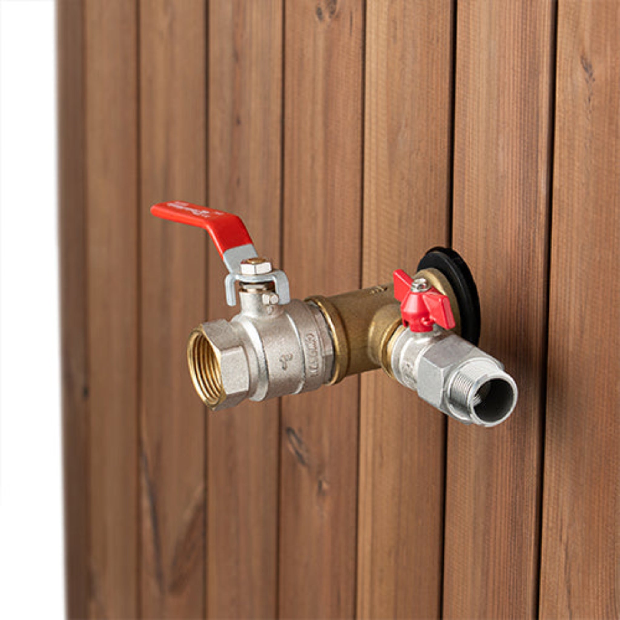 Brass outdoor faucet with red handles attached to Saunalife S1N immersion tub