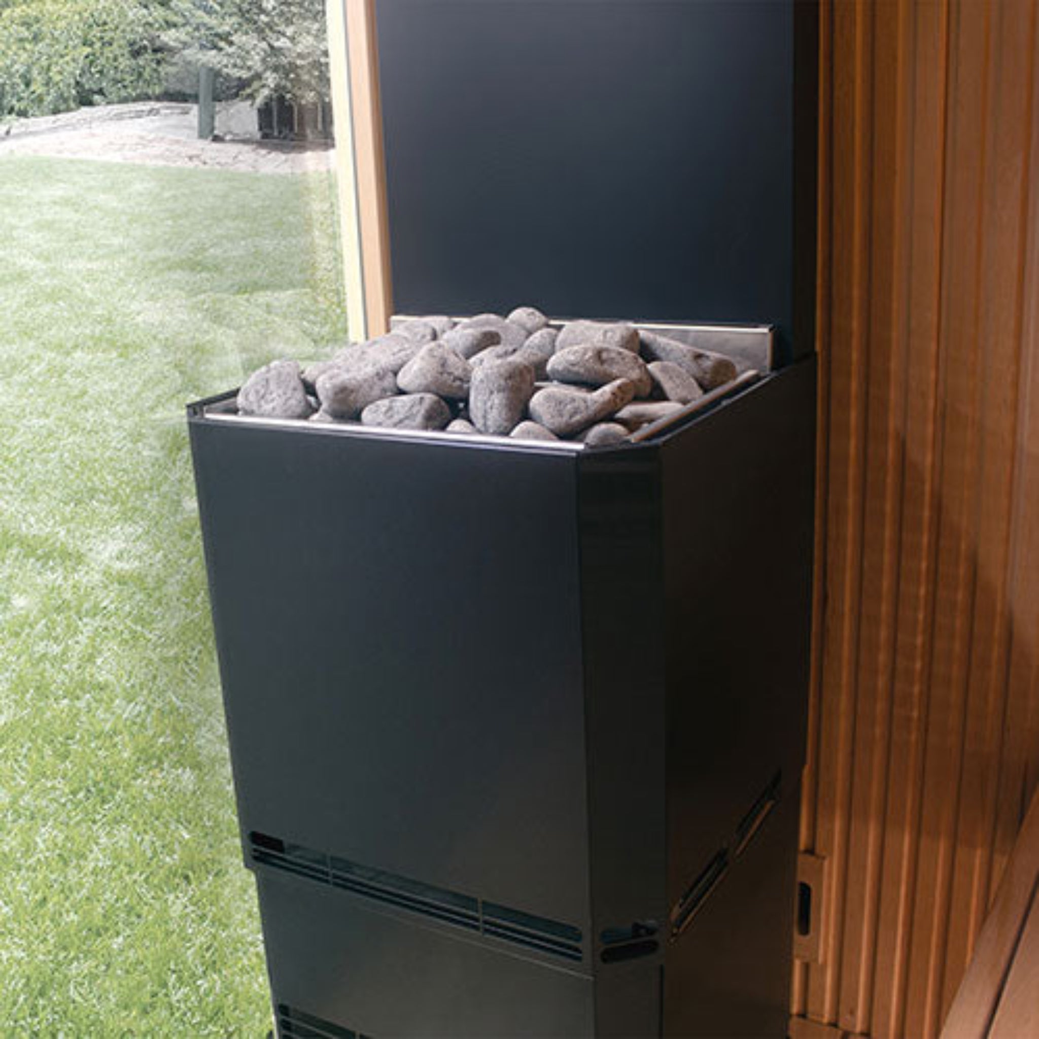 Saunum Air L Sauna Heater - Black angle view - by a sauna window in a backyard setting