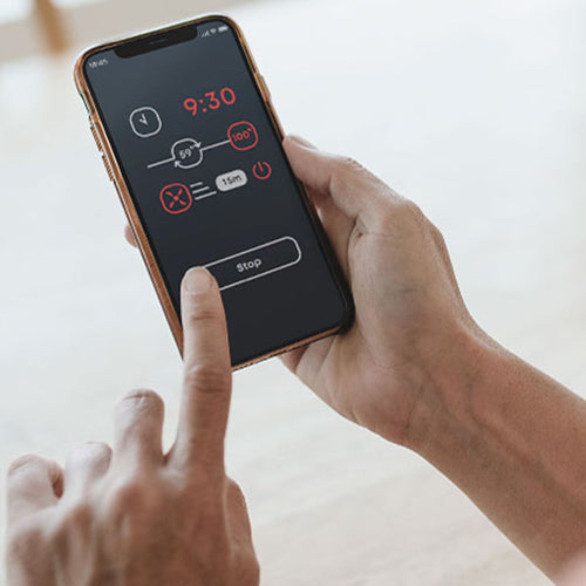 Person holding the Saunum IQ WiFI with a timer app on the screen