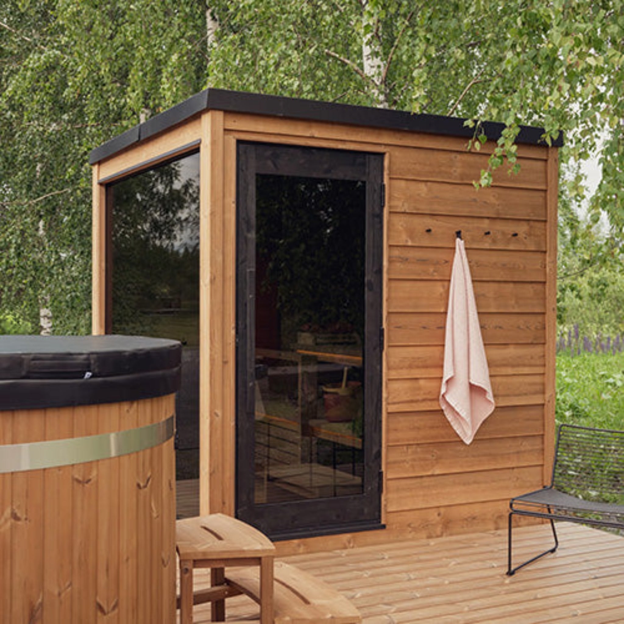 ThermasSol Nordic Dawn sauna showing the door and window in a back yard setting