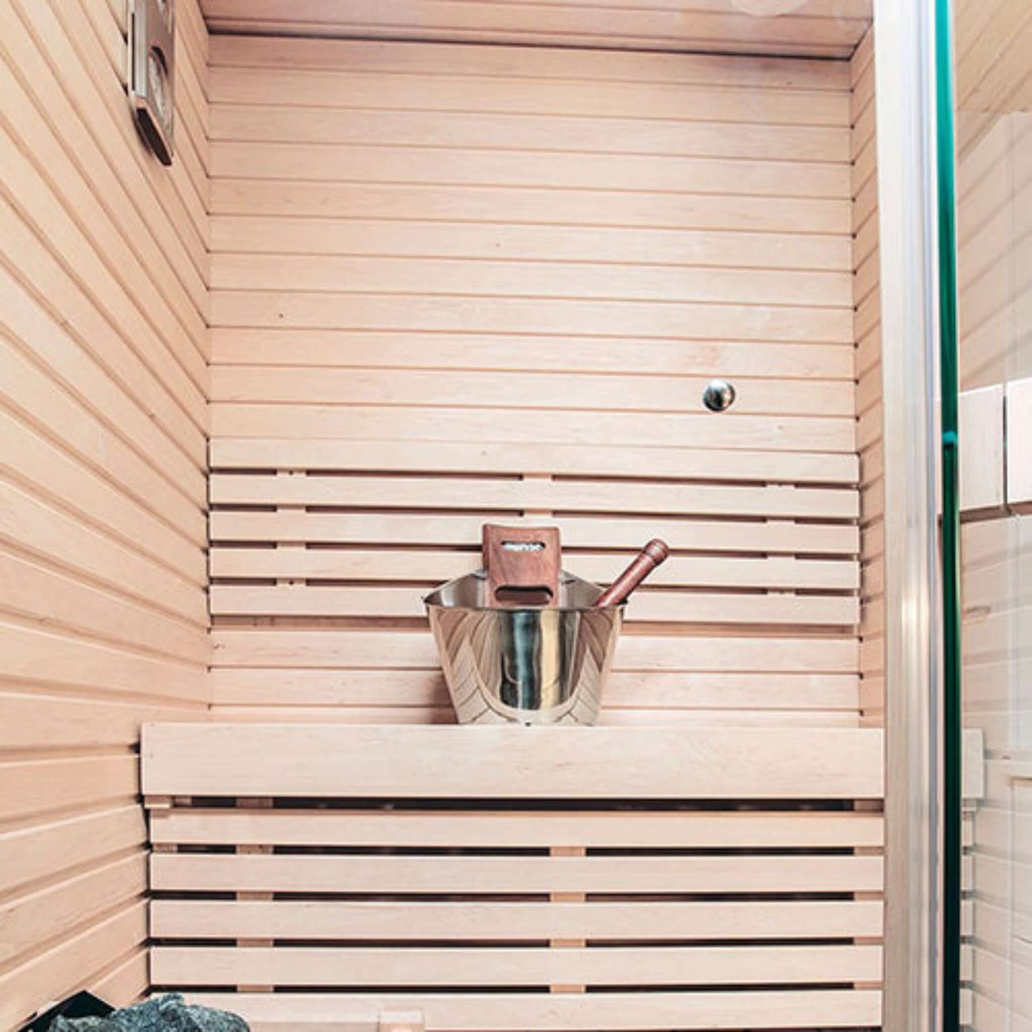 Harvia sauna accessory set — full collection laid out including bucket, ladle and gauges lifestyle view