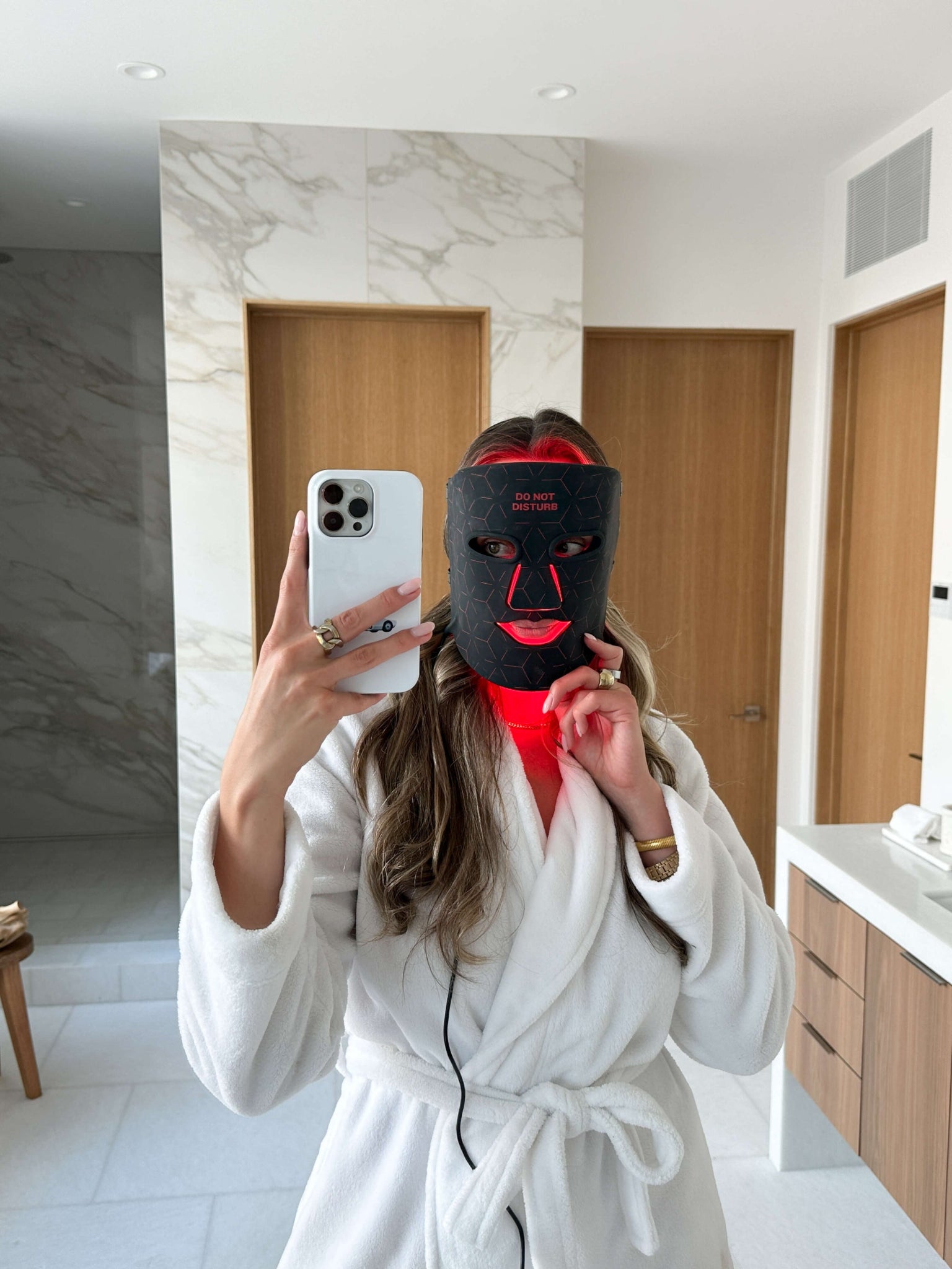 Woman wearing Renew Red Light LED Therapy Mask during at-home skincare session