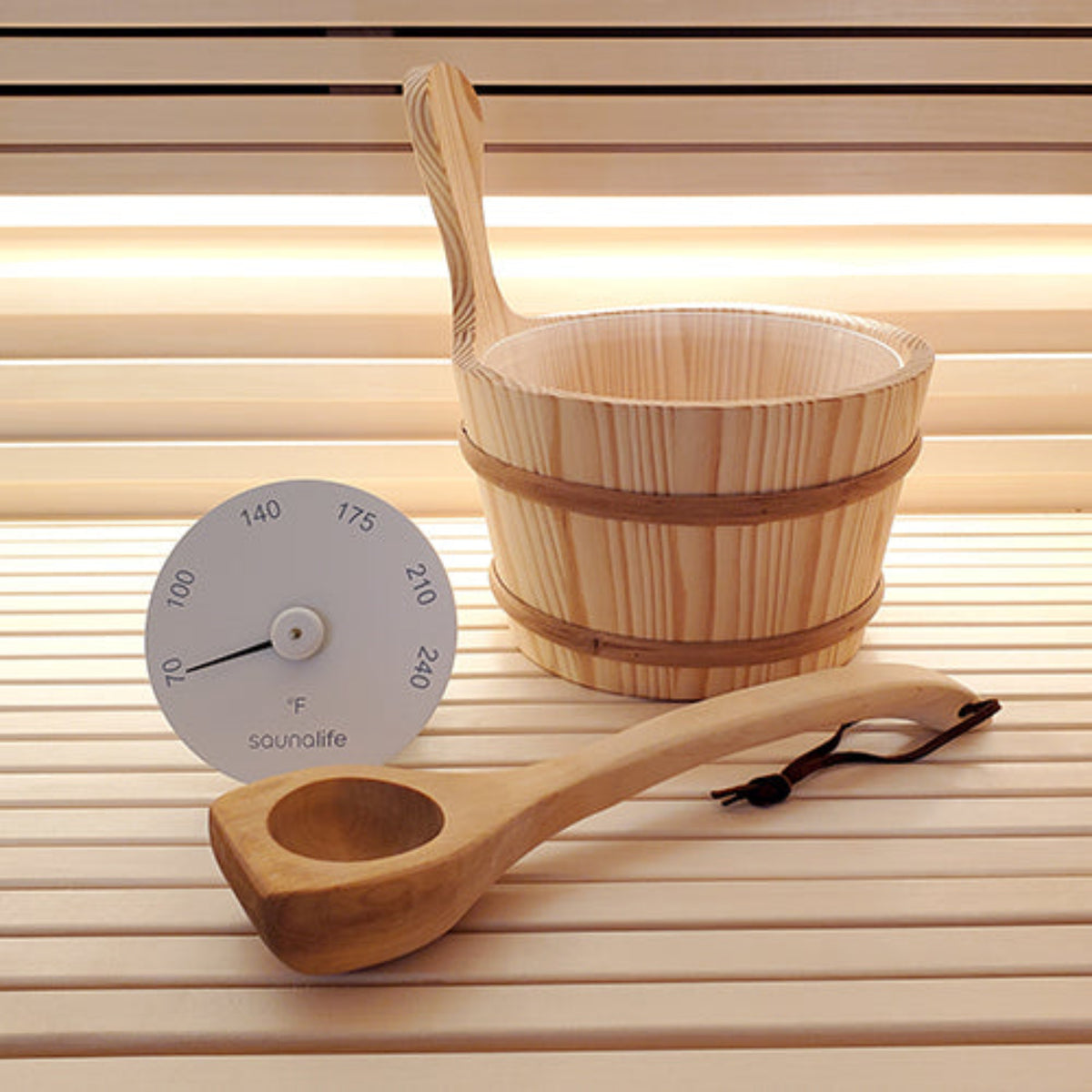 Wood Sauna Bucket and Ladle Set w/ white Thermometer on a wooden sauna bench