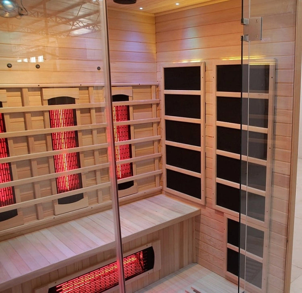 Interior view of Blisspod Venetian full spectrum infrared sauna with low EMF, featuring red heating panels and comfortable seating.