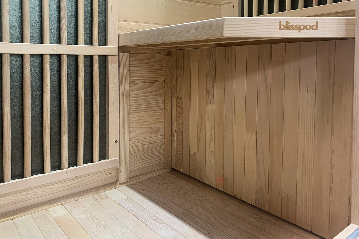 Interior view of Blisspod Vienna 1-Person Far Infrared Sauna showcasing natural wood design.