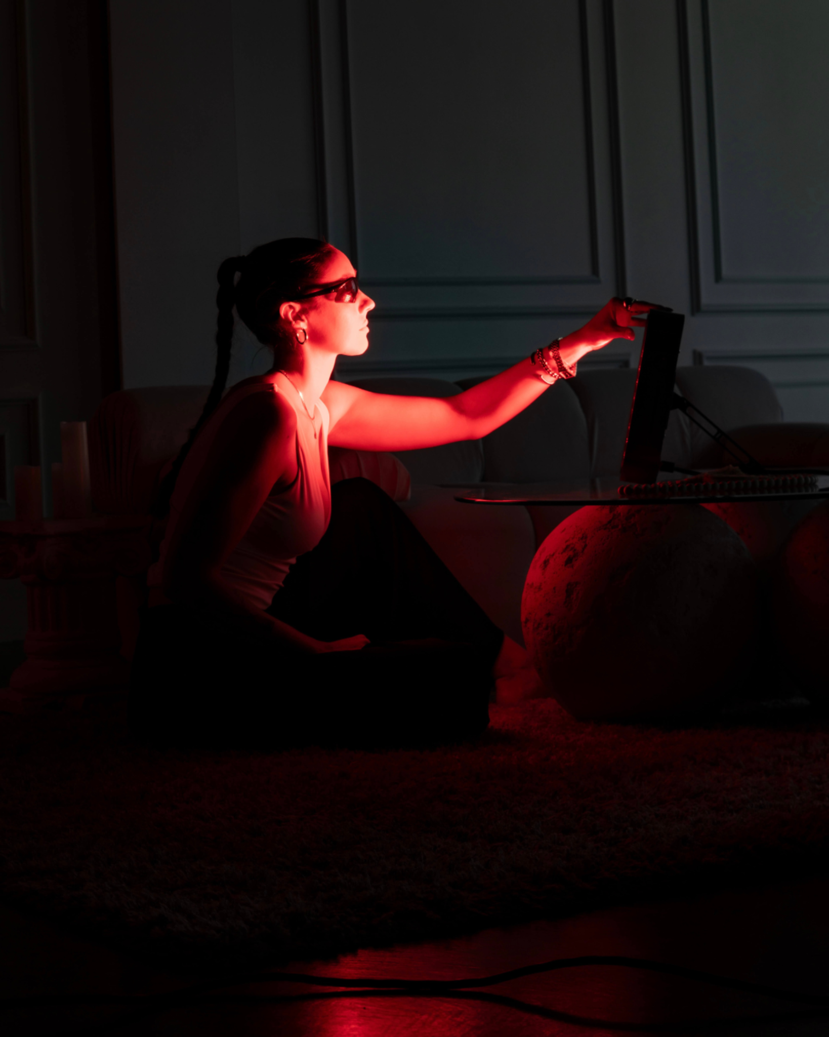 Woman using Renew Red Light Small Panel portable red light therapy device