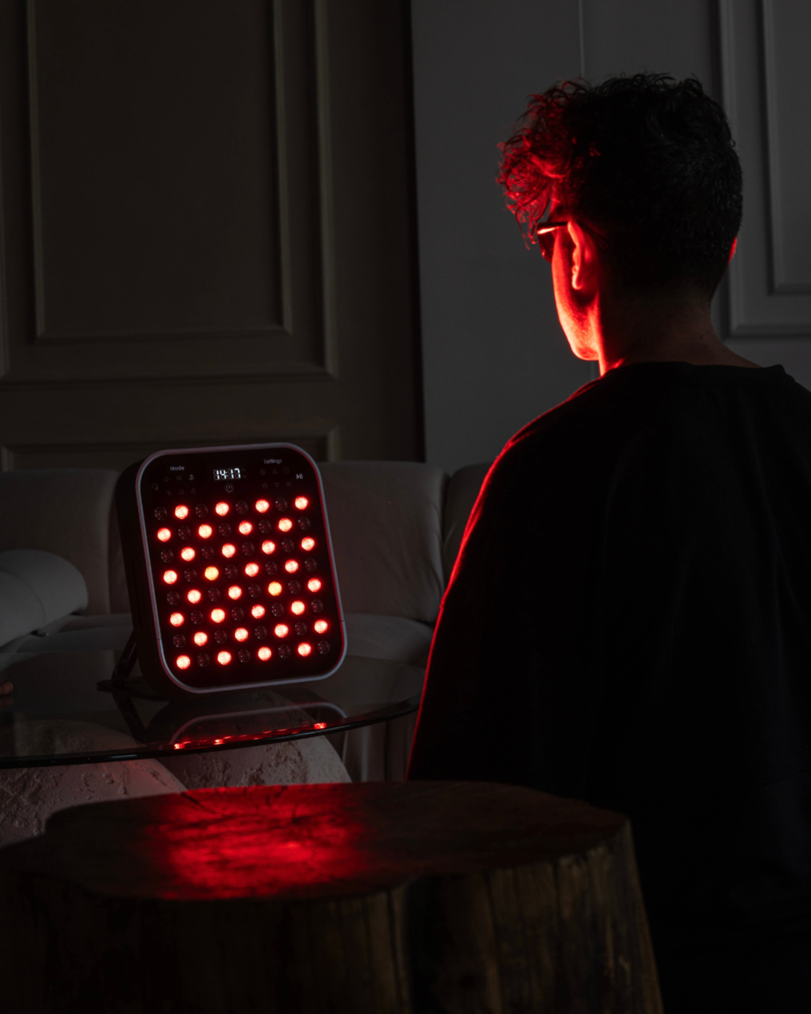 man using Renew Red Light Small Panel portable red light therapy device
