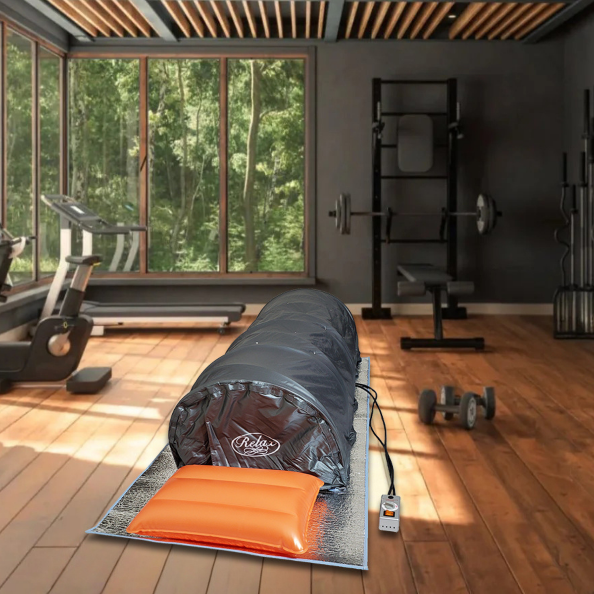 Infrared sauna set up in a home gym, featuring a black sauna tent and an orange cushion.