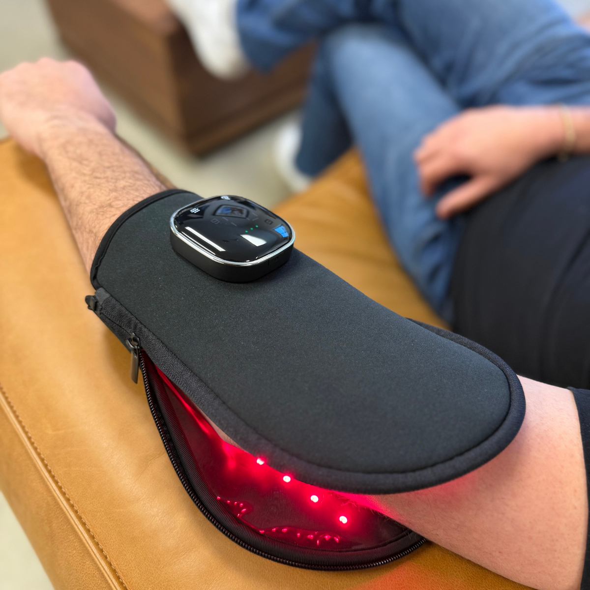 TheraGlove Red Light Therapy Glove worn on arm, featuring red and near-infrared light technology.