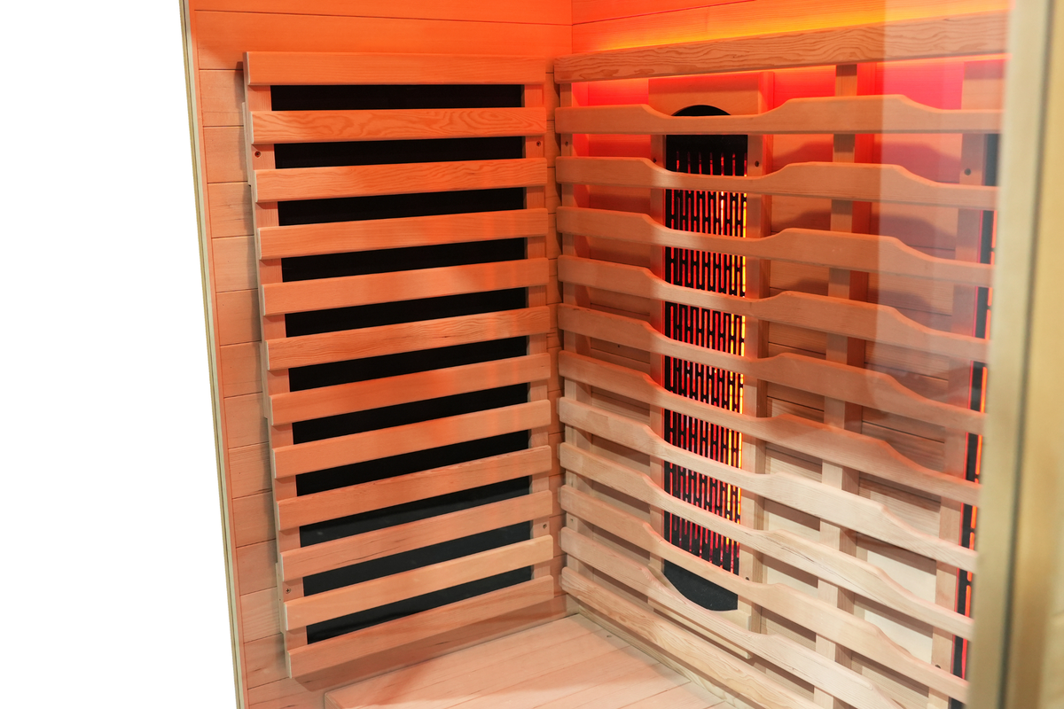 Interior view of a full spectrum infrared sauna with red light therapy panels and wooden seating.