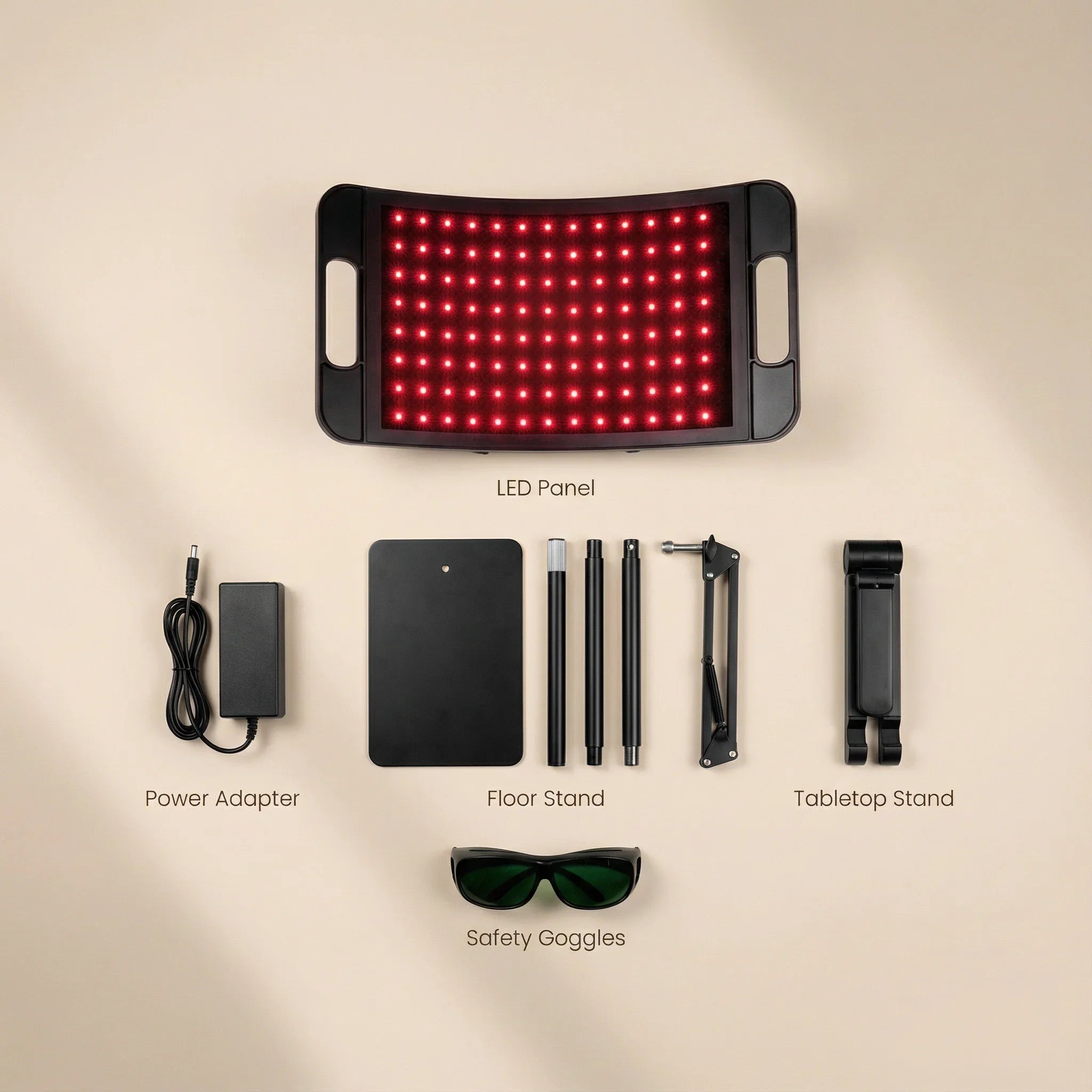 LED panel with power adapter, floor stand, tabletop stand, and safety goggles on a beige background