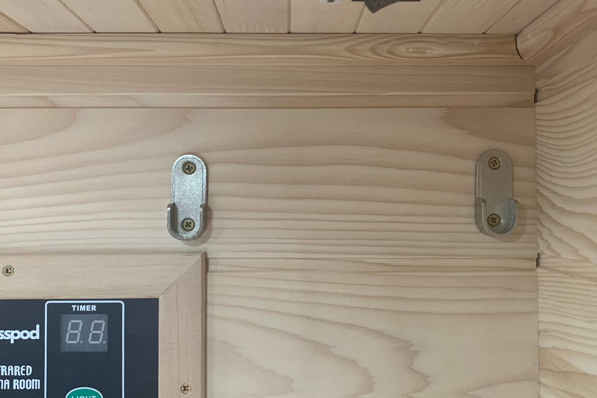 Hardware components of the Blisspod Vienna Far Infrared Sauna featuring timer display and wall hooks.