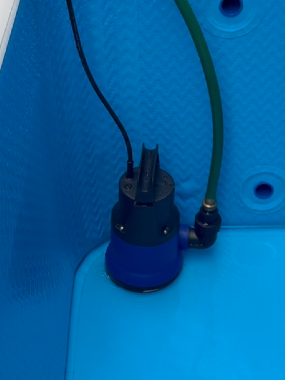 RevX drain pump inside a cold plunge tub