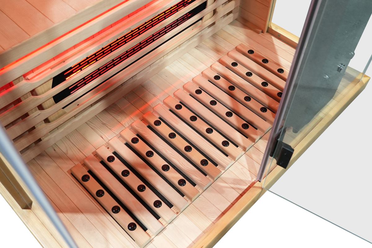 Interior view of a full spectrum infrared sauna with red light therapy showing the wooden slats and heating panels.