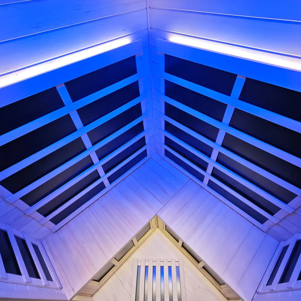 Interior view of a corner infrared sauna for 2-3 people showing blue lighting and wooden beams.