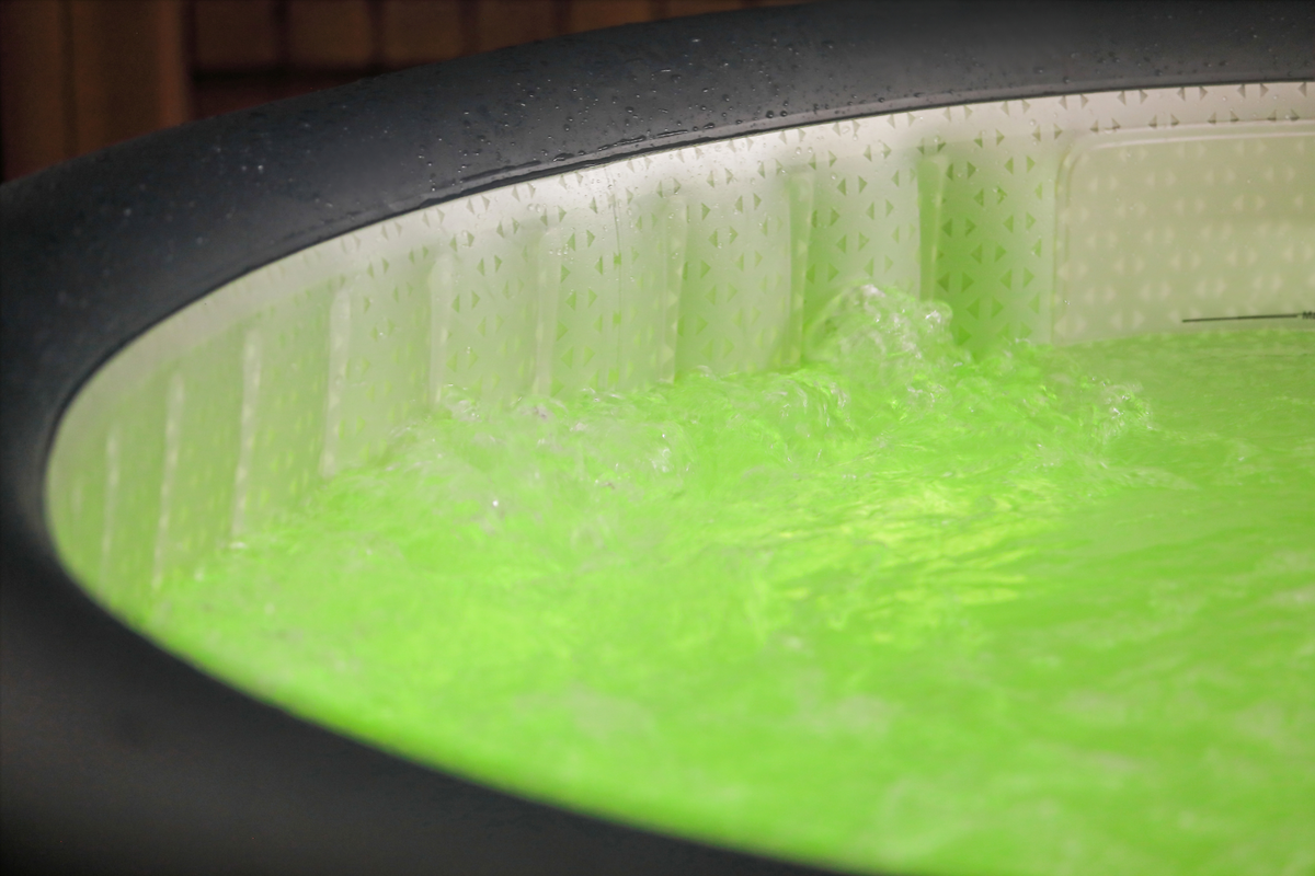 Close-up of a green gel-like substance in a container with a textured surface.