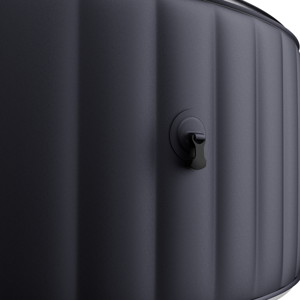 Close-up of a dark charcoal gray inflatable hot tub with vertical ribbing and a black spout connector on the side.