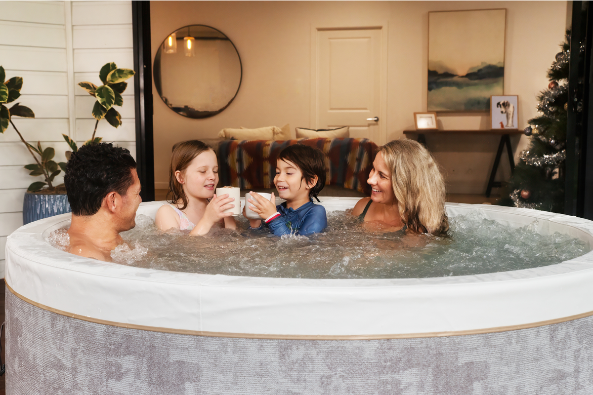 Family enjoying the MSPA Cocoon rigid hot tub, relaxing in warm water and sharing drinks together.