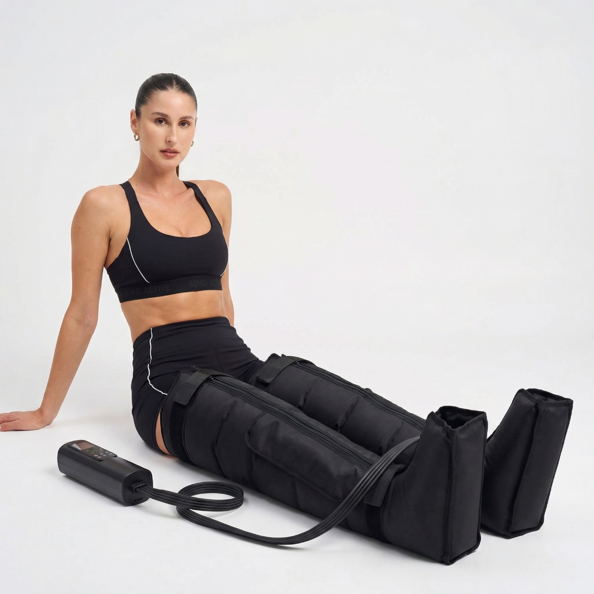 Woman using a black compression device on a white background