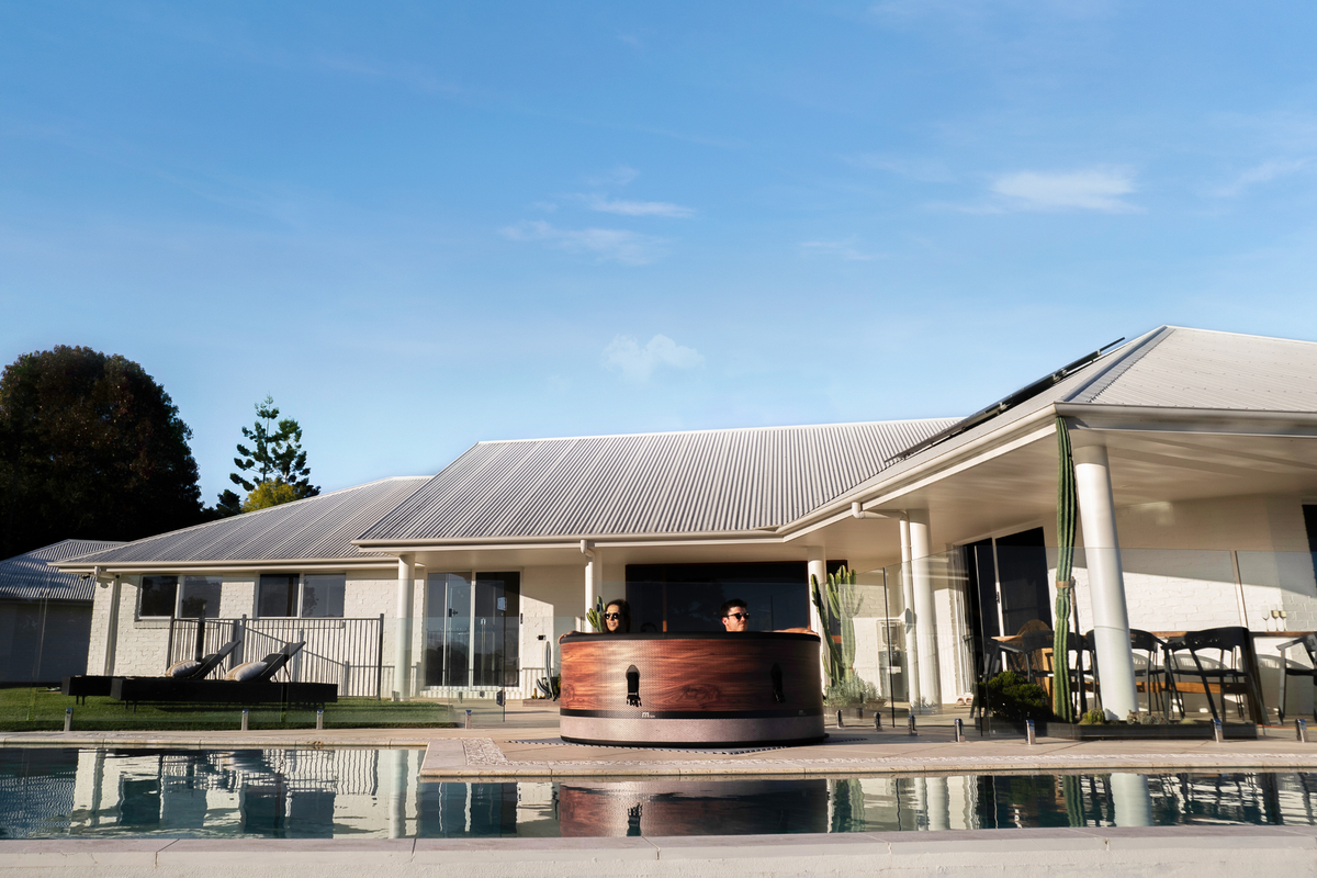 A rigid hot tub beside a modern home, perfect for relaxation and enjoyment with family and friends.