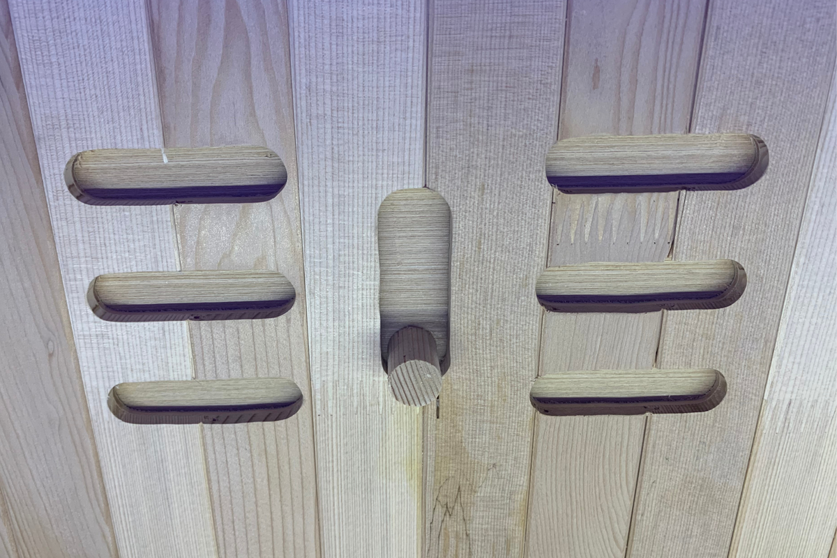 Close-up of wooden interior panel of a Full Spectrum Indoor Sauna, showcasing craftsmanship and design.