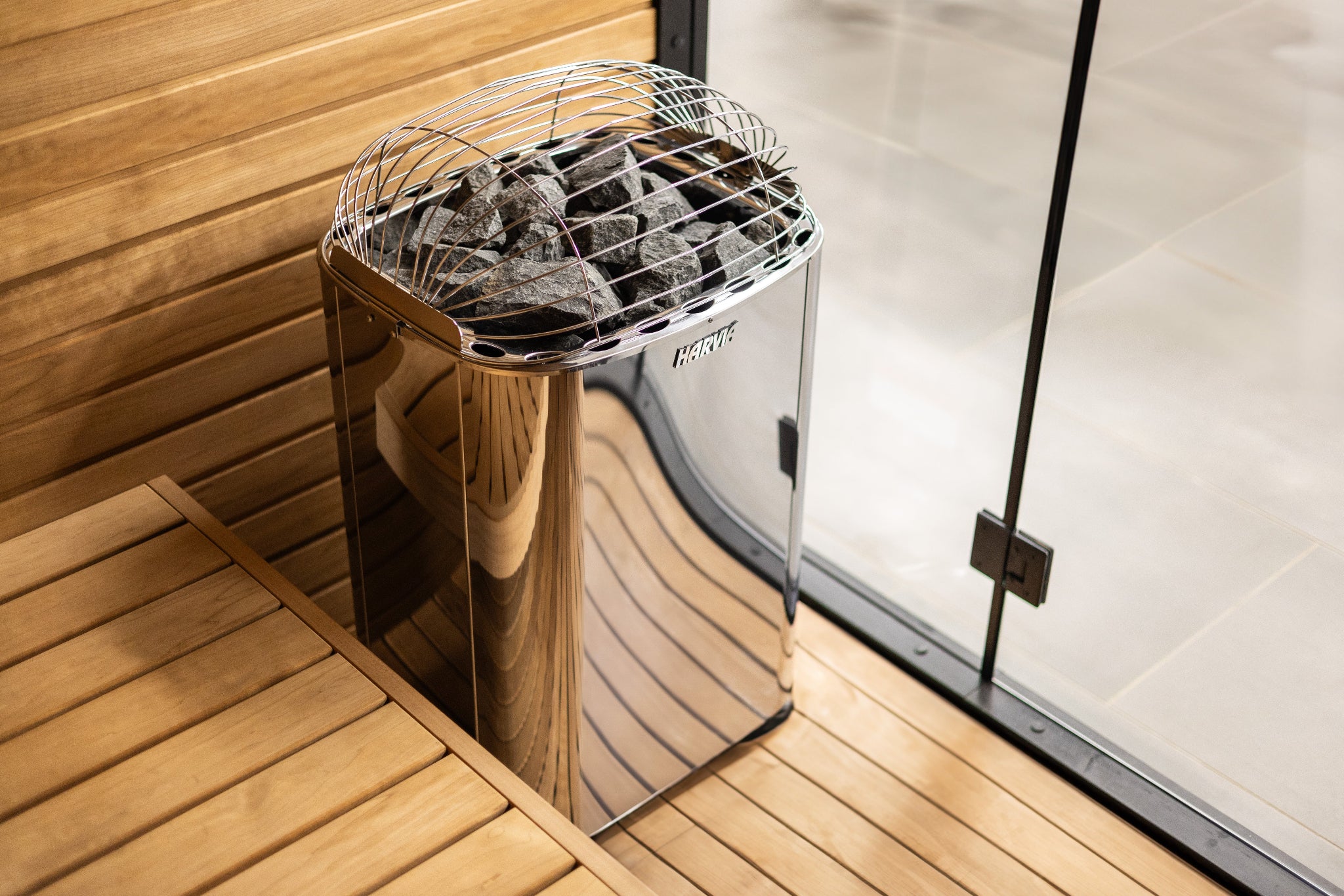Harvia Club K15G sauna heater installed indoors — quarter angle view in traditional sauna room