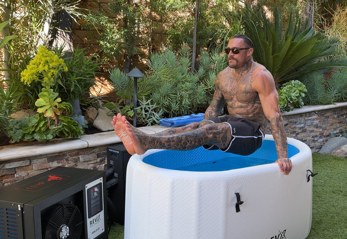 Person sitting on the edge of a RevX inflatable tub